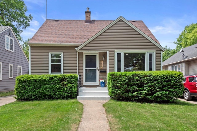 165 N 72nd St, Milwaukee, WI 53213 - bungalow with a front lawn, a chimney, and roof with shingles
