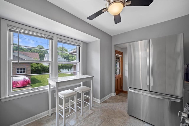 165 N 72nd St, Milwaukee, WI 53213 - kitchen featuring freestanding refrigerator, a ceiling fan, and light stone counters