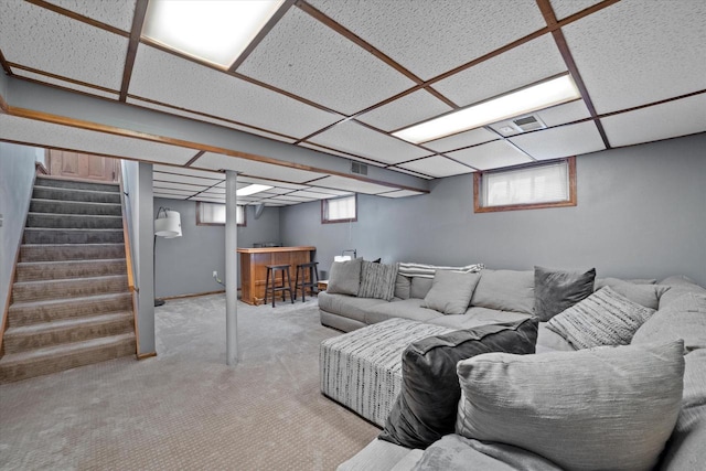 165 N 72nd St, Milwaukee, WI 53213 - carpeted living area with a bar, stairs, and a paneled ceiling