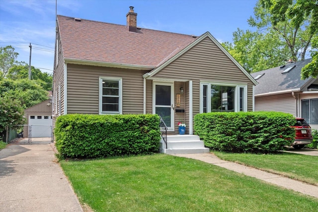 165 N 72nd St, Milwaukee, WI 53213 - view of front of home featuring a chimney, a gate, roof with shingles, and a detached garage