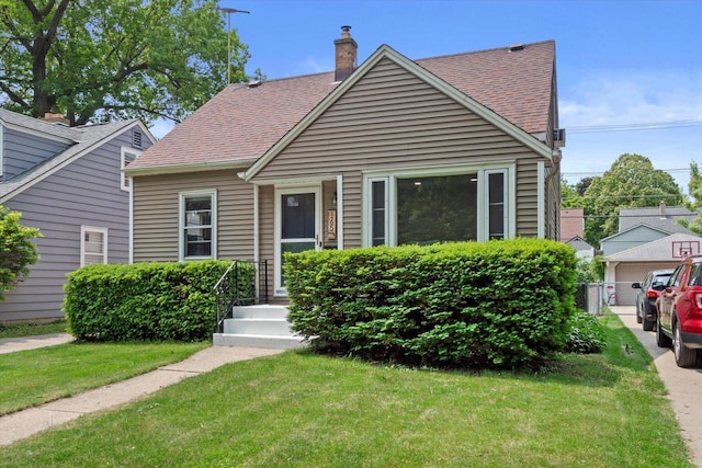 165 N 72nd St, Milwaukee, WI 53213 - view of front of property featuring a front yard, a shingled roof, and a chimney