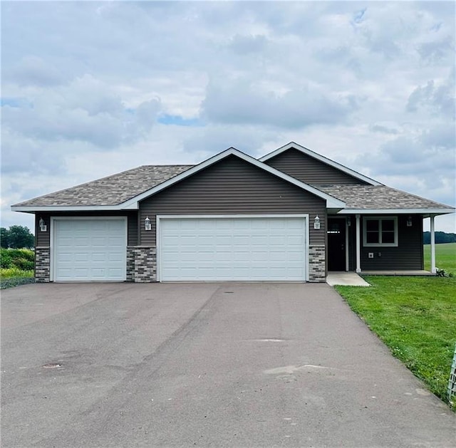 308 Dunn St, Colfax, WI 54730 - ranch-style house featuring an attached garage, asphalt driveway, a front lawn, and roof with shingles