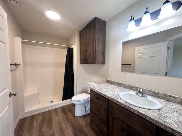 308 Dunn St, Colfax, WI 54730 - bathroom featuring wood finished floors, vanity, and a shower with shower curtain