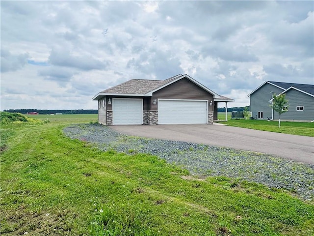 308 Dunn St, Colfax, WI 54730 - view of front of home with a front lawn, stone siding, an outdoor structure, and a garage