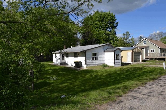 653 Grant St, Wonewoc, WI 53968 - view of front of property with a garage, a front yard, entry steps, and driveway