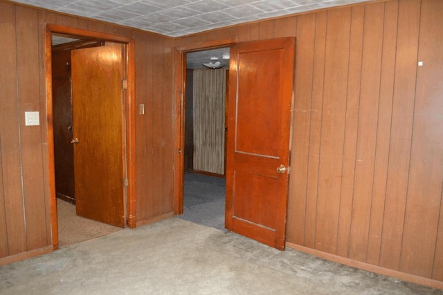 653 Grant St, Wonewoc, WI 53968 - spare room with wood walls and carpet floors