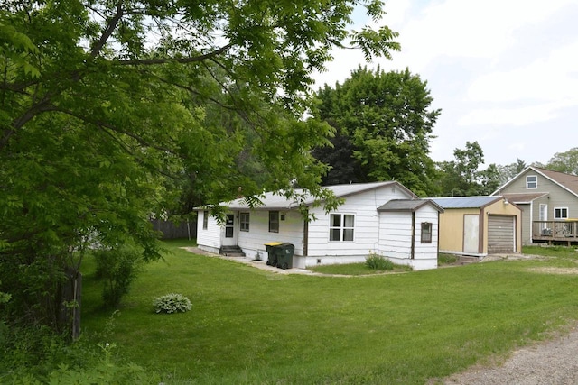 653 Grant St, Wonewoc, WI 53968 - view of front of house with a garage and a front lawn