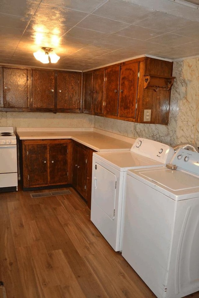 653 Grant St, Wonewoc, WI 53968 - washroom featuring washer and clothes dryer and wood finished floors