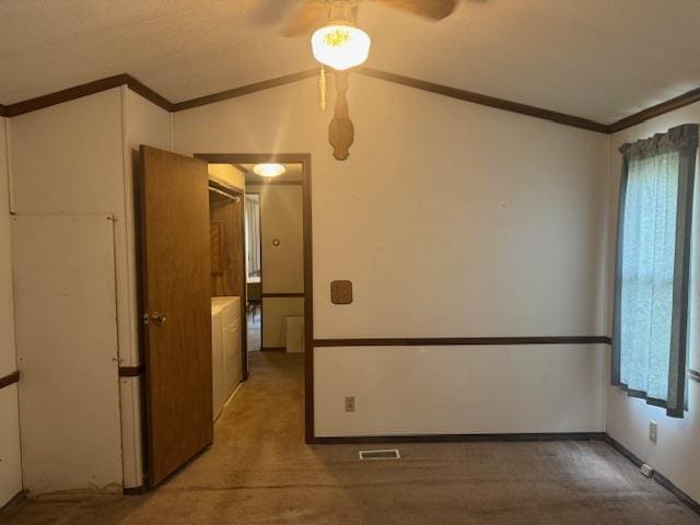W211N11783 Hilltop Cir, Germantown, WI 53022 - carpeted spare room with vaulted ceiling, a ceiling fan, and ornamental molding