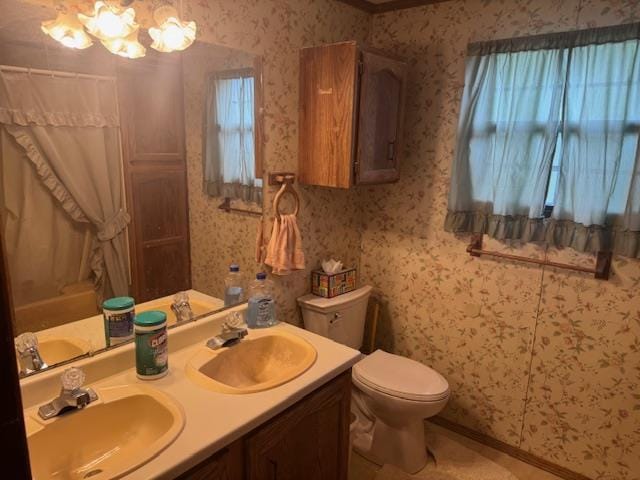W211N11783 Hilltop Cir, Germantown, WI 53022 - bathroom with wallpapered walls, double vanity, a chandelier, and a shower with curtain