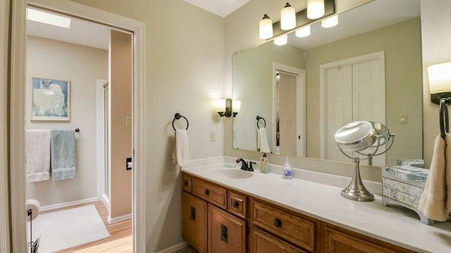 514 Fairfield Ct, Chippewa Falls, WI 54729 - full bathroom featuring vanity, a shower, and wood finished floors