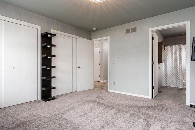 850 E Mckearn Ln, Beloit, WI 53511 - unfurnished bedroom with multiple closets, carpet floors, and ensuite bathroom
