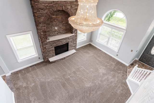 850 E Mckearn Ln, Beloit, WI 53511 - unfurnished living room with a fireplace, carpet floors, and a high ceiling