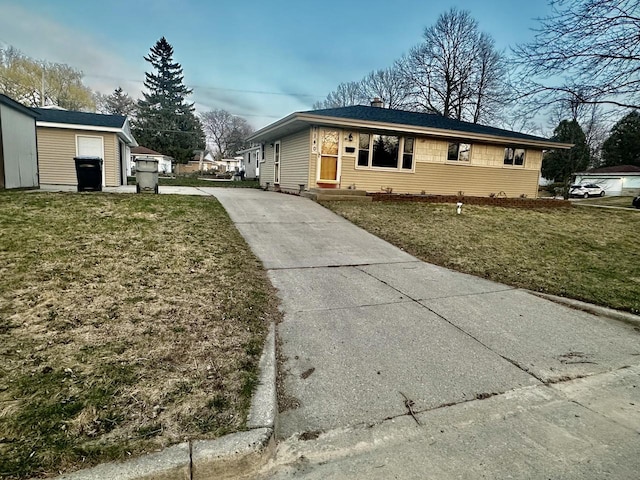 7140 N 48th St, Milwaukee, WI 53223 - view of front facade with driveway, a front lawn, and a chimney