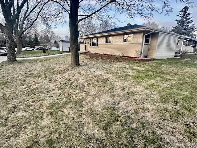 7140 N 48th St, Milwaukee, WI 53223 - view of property exterior with a chimney and a lawn