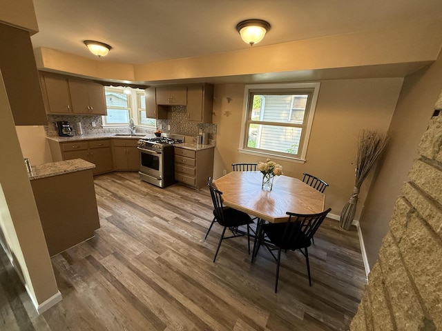 7140 N 48th St, Milwaukee, WI 53223 - kitchen featuring stainless steel gas stove, wood finished floors, backsplash, and gray cabinets