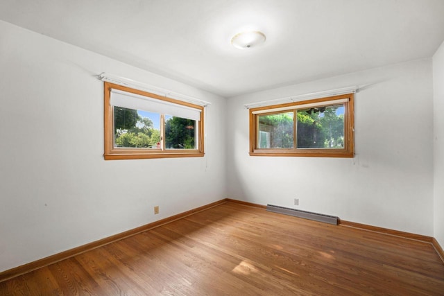 5110 W Cleveland Ave, Milwaukee, WI 53219 - unfurnished room featuring a baseboard radiator, healthy amount of natural light, and wood finished floors