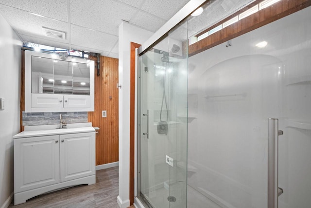 5110 W Cleveland Ave, Milwaukee, WI 53219 - full bathroom featuring a stall shower, vanity, wood finished floors, and a paneled ceiling