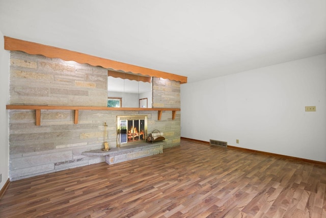5110 W Cleveland Ave, Milwaukee, WI 53219 - unfurnished living room with wood finished floors and a stone fireplace