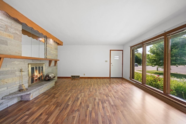 5110 W Cleveland Ave, Milwaukee, WI 53219 - unfurnished living room featuring wood finished floors and a stone fireplace
