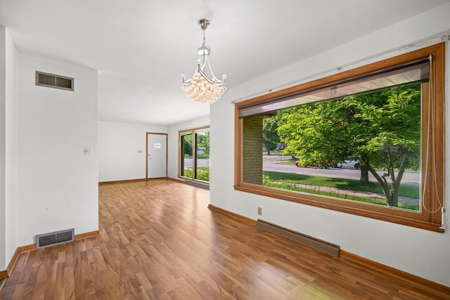 5110 W Cleveland Ave, Milwaukee, WI 53219 - spare room with wood finished floors and a chandelier