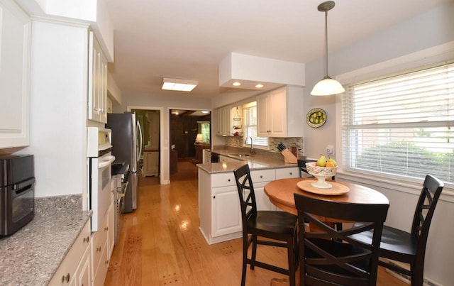 4729 James Ave, Wind Point, WI 53402 - dining area with light wood finished floors and plenty of natural light