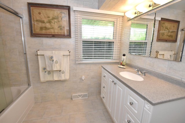 4729 James Ave, Wind Point, WI 53402 - full bath featuring tile walls, vanity, tile patterned flooring, and shower / bath combination with glass door
