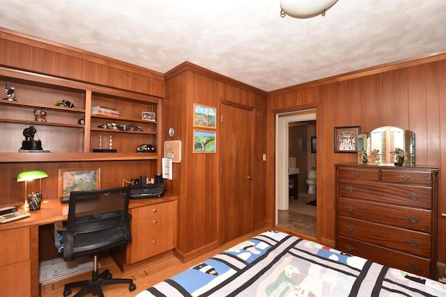 4729 James Ave, Wind Point, WI 53402 - bedroom featuring built in study area, wood walls, crown molding, and light wood-style floors