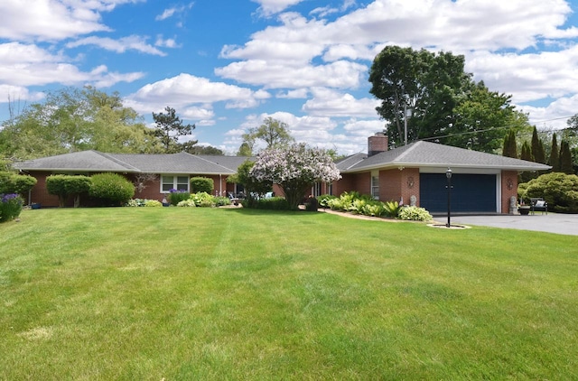 4729 James Ave, Wind Point, WI 53402 - view of green lawn with an attached garage and asphalt driveway