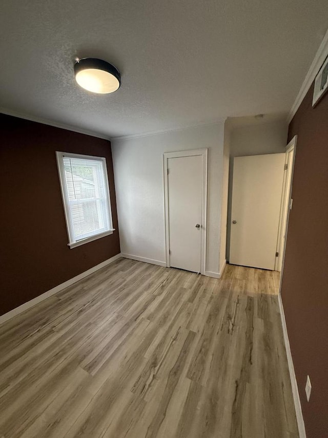 5411 N 37th St, Milwaukee, WI 53209 - unfurnished bedroom featuring light wood-style floors, a textured ceiling, and crown molding
