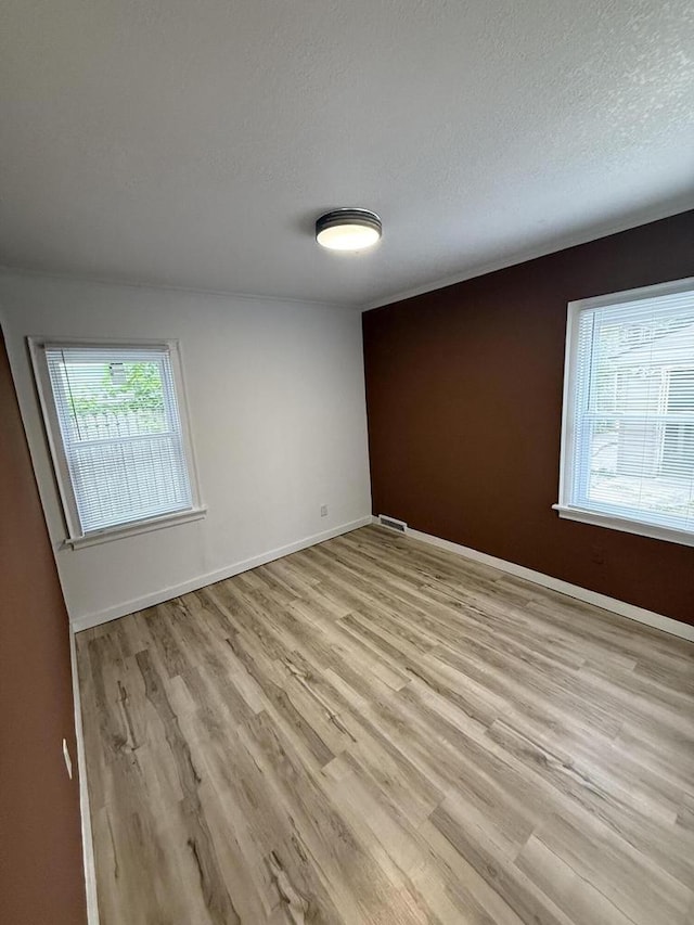 5411 N 37th St, Milwaukee, WI 53209 - unfurnished room with light wood-style flooring, plenty of natural light, and a textured ceiling