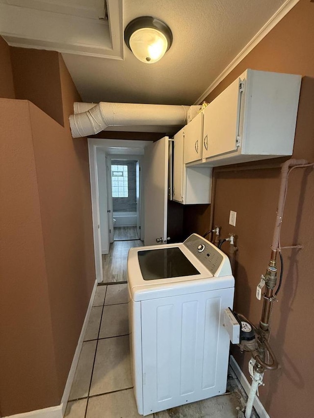 5411 N 37th St, Milwaukee, WI 53209 - laundry room featuring washer / clothes dryer, cabinet space, light tile patterned flooring, and a textured ceiling