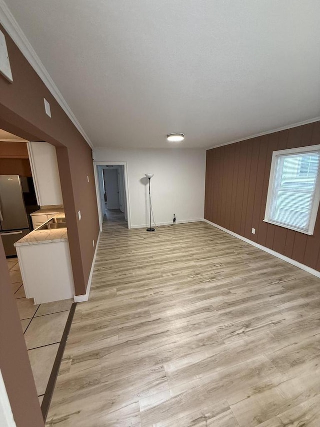 5411 N 37th St, Milwaukee, WI 53209 - unfurnished living room with light wood-style flooring and crown molding