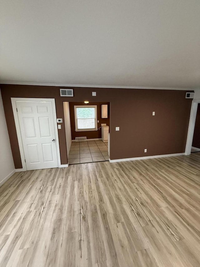 5411 N 37th St, Milwaukee, WI 53209 - unfurnished living room featuring light wood-style flooring and crown molding