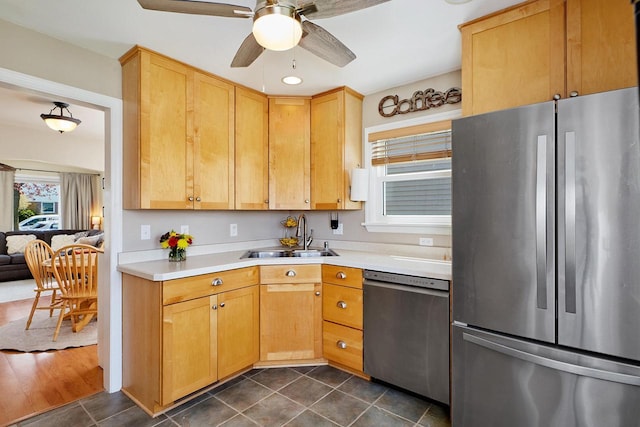 3057 N 90th St, Milwaukee, WI 53222 - kitchen featuring stainless steel appliances, light countertops, ceiling fan, dark tile patterned flooring, and light brown cabinetry