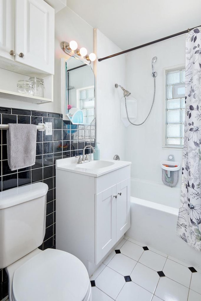 3057 N 90th St, Milwaukee, WI 53222 - full bath featuring vanity, shower / bathtub combination with curtain, tile patterned floors, and tile walls