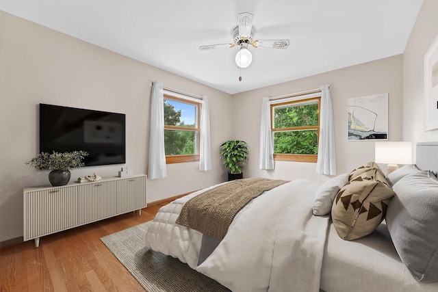 6500 S 121st St, Franklin, WI 53132 - bedroom featuring multiple windows, wood finished floors, and a ceiling fan