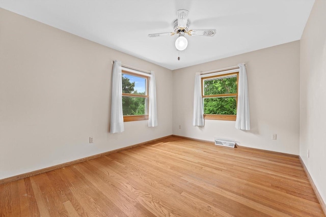 6500 S 121st St, Franklin, WI 53132 - unfurnished room with healthy amount of natural light, light wood finished floors, and ceiling fan