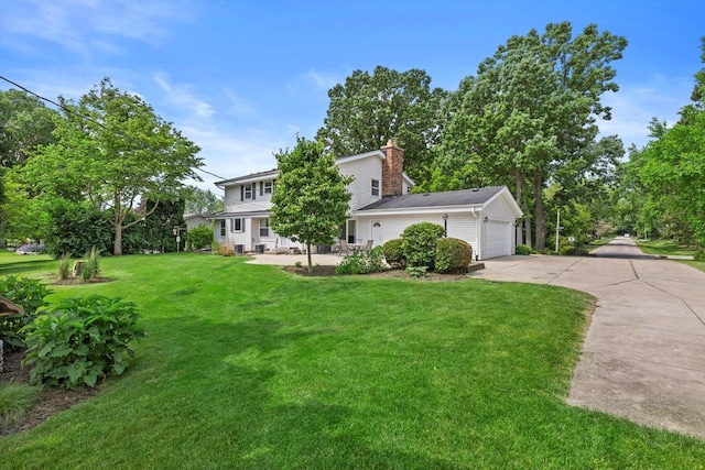 6500 S 121st St, Franklin, WI 53132 - view of front of property with driveway, a front lawn, a chimney, and a garage