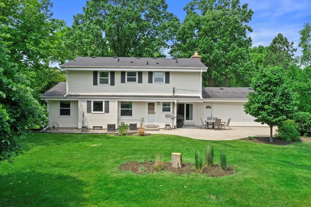 6500 S 121st St, Franklin, WI 53132 - back of property with a patio, entry steps, a lawn, and a chimney