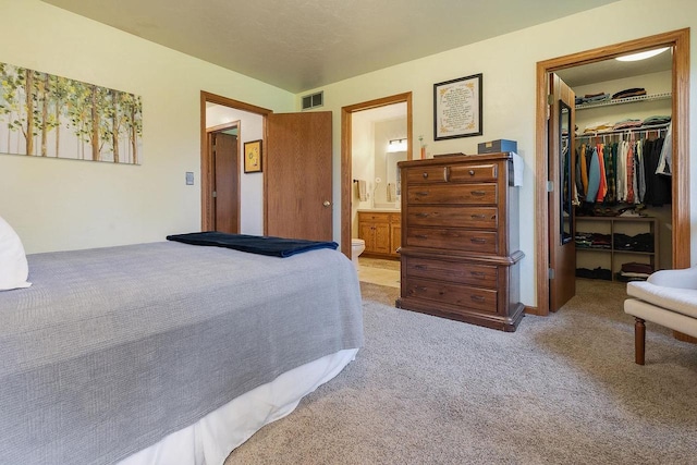 431 Ridgeway Dr, Brillion, WI 54110 - bedroom with a spacious closet, a closet, light colored carpet, and ensuite bath