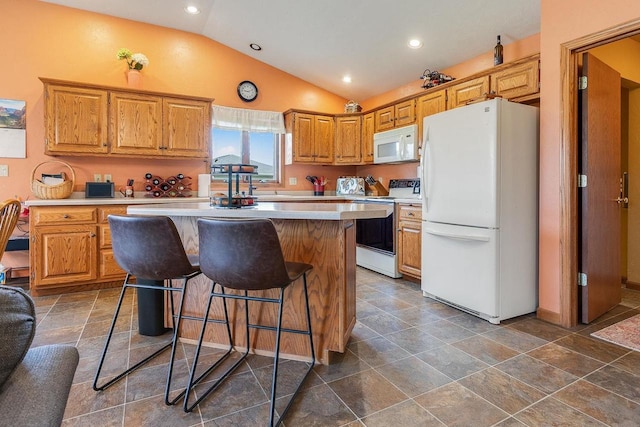 431 Ridgeway Dr, Brillion, WI 54110 - kitchen with white appliances, light countertops, lofted ceiling, a center island, and a kitchen bar