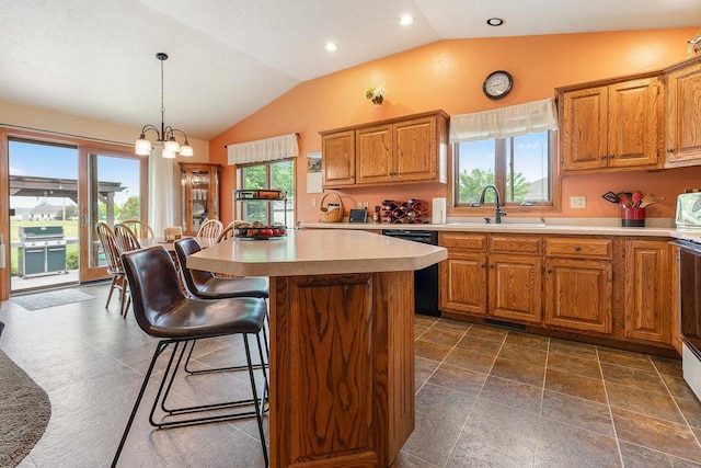 431 Ridgeway Dr, Brillion, WI 54110 - kitchen with vaulted ceiling, black dishwasher, brown cabinetry, light countertops, and a kitchen breakfast bar