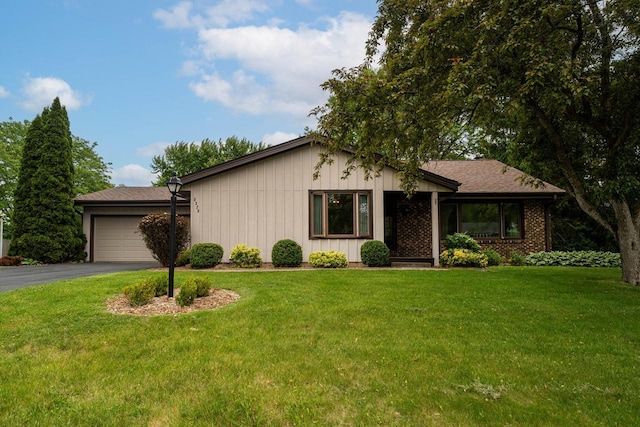 5325 Linden Cir, Racine, WI 53406 - view of front facade featuring asphalt driveway, a garage, and a front lawn