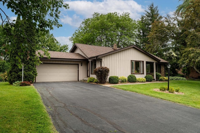 5325 Linden Cir, Racine, WI 53406 - single story home featuring asphalt driveway, an attached garage, a front lawn, a chimney, and a shingled roof
