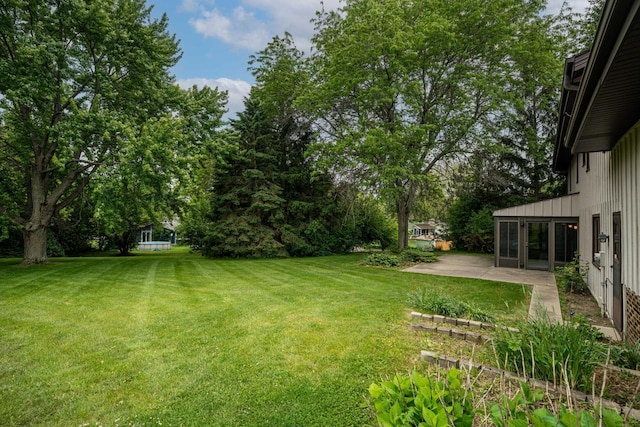 5325 Linden Cir, Racine, WI 53406 - view of green lawn featuring a patio and view of scattered trees