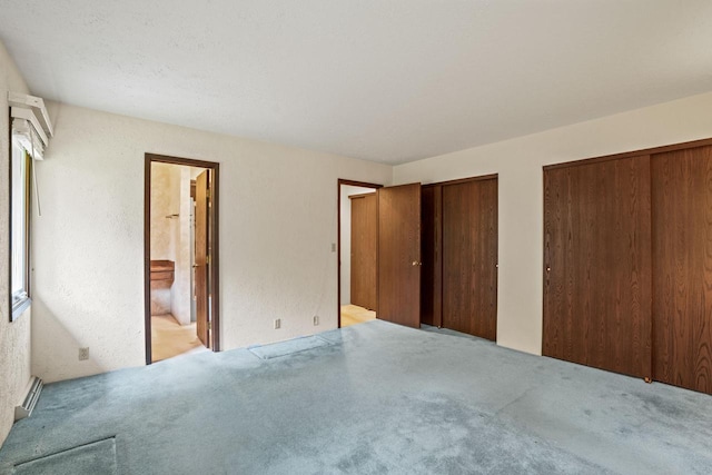 5325 Linden Cir, Racine, WI 53406 - unfurnished bedroom with two closets, carpet floors, a baseboard radiator, and connected bathroom