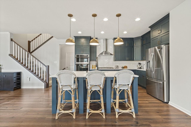 7949 W Oakwood Way, Franklin, WI 53132 - kitchen with stainless steel appliances, light countertops, wall chimney exhaust hood, dark wood-style floors, and recessed lighting
