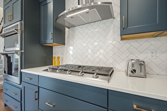 7949 W Oakwood Way, Franklin, WI 53132 - kitchen with ventilation hood, blue cabinets, and backsplash