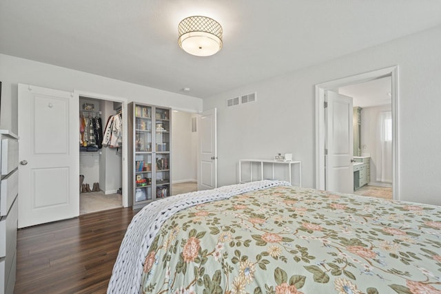 7949 W Oakwood Way, Franklin, WI 53132 - bedroom with wood finished floors, a spacious closet, ensuite bathroom, and a closet